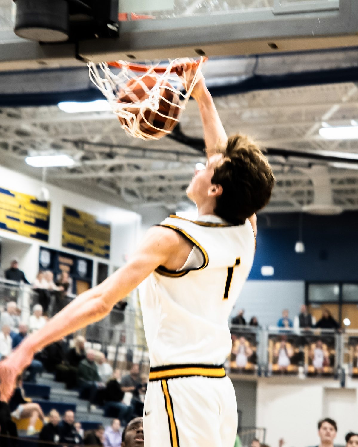 Basketball player dunking during a game