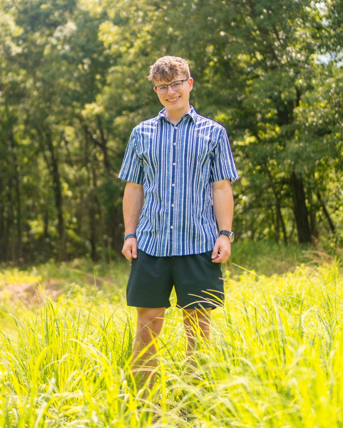 Senior portrait, outdoors in a sunlit field