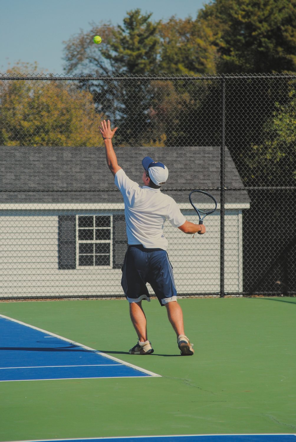 Tennis player serving on the court